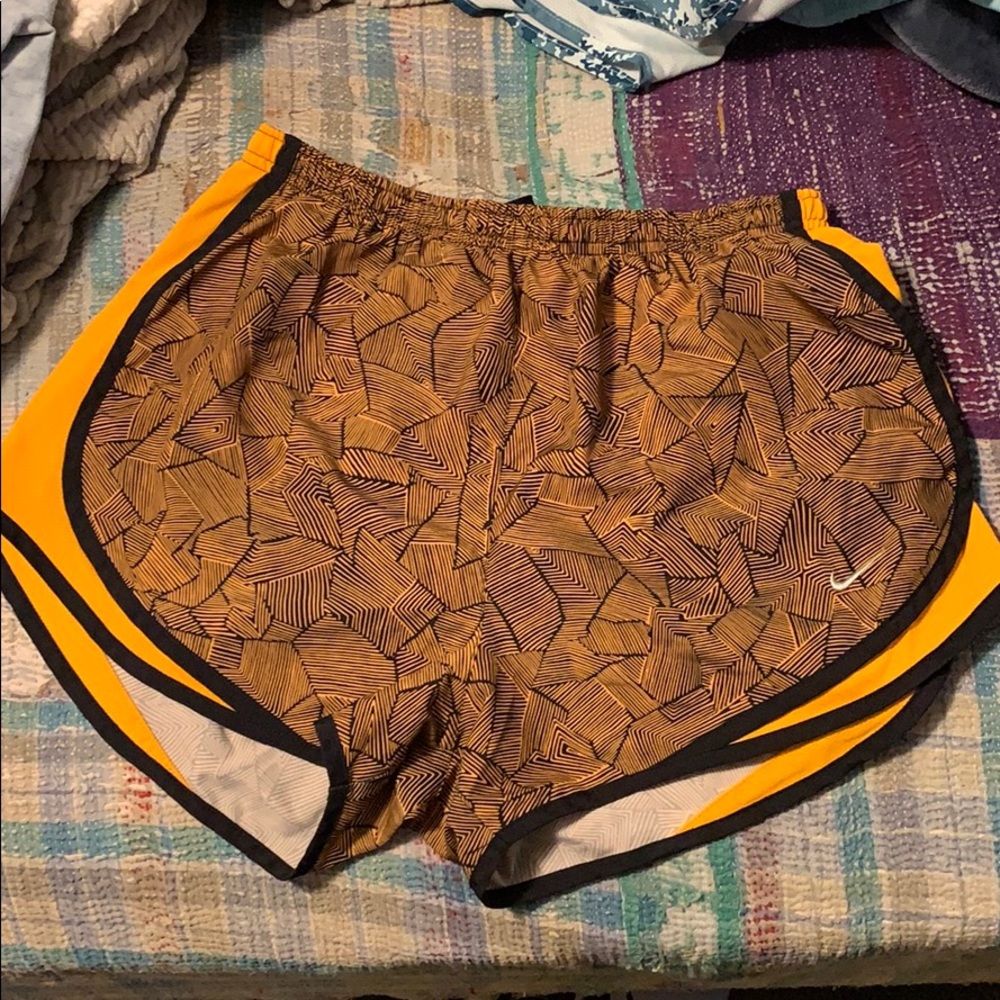 Orange and black nike running shorts